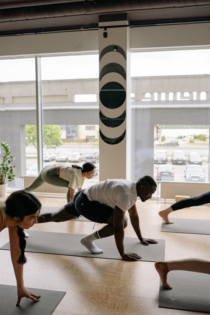 Mastering the First Impression: Your intriguing post title goes here A diverse group of adults practicing yoga poses indoors, promoting fitness and wellness.